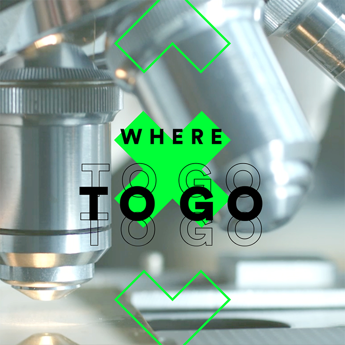 In the centre of the picture there is an arrow pointing upwards at the top, an arrow pointing downwards at the bottom and an X in the middle with the words ‘Where to go’, with a microscope in the background (Photo)