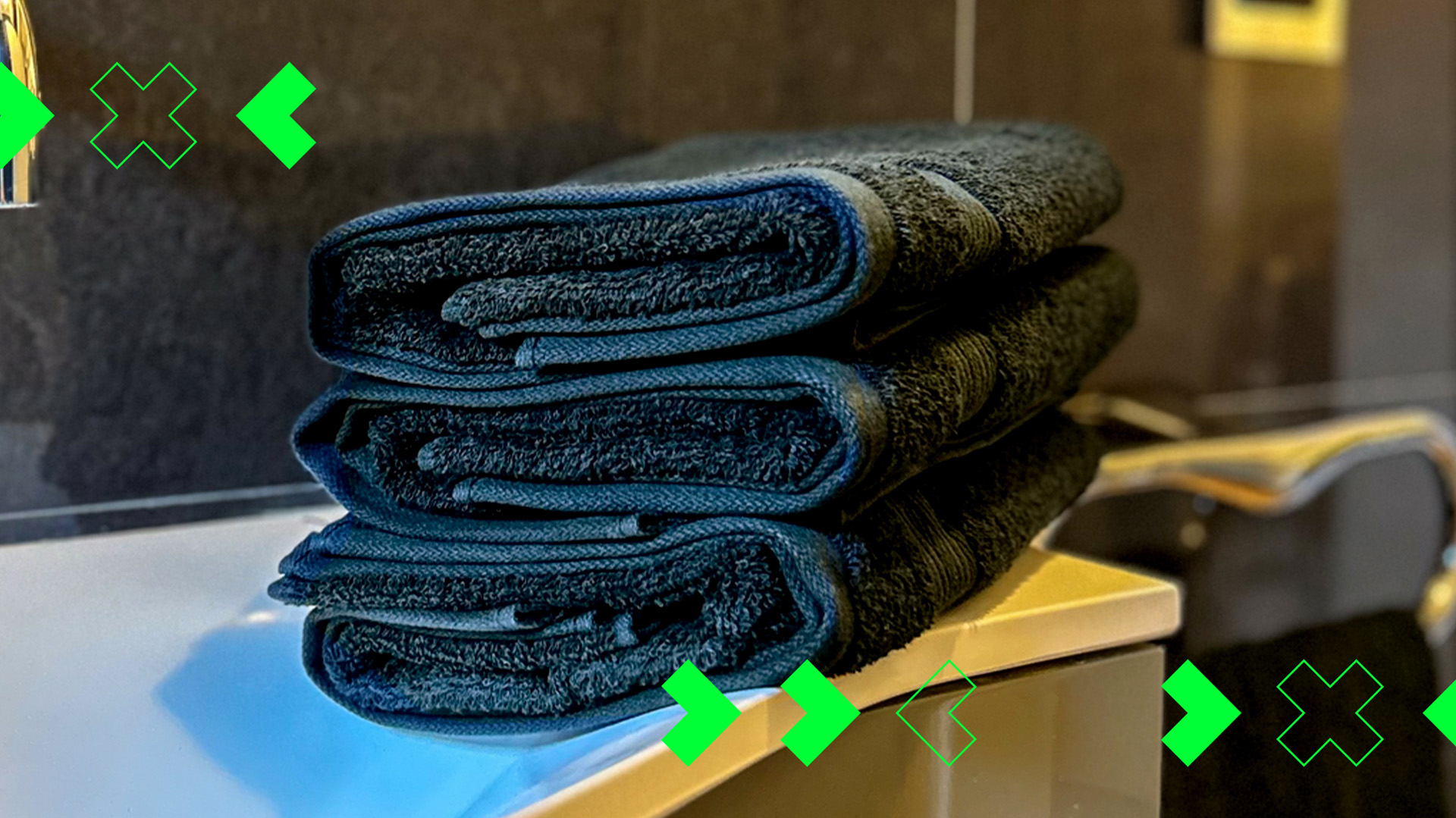 Photo of black towels with graphic elements on them; green arrows and X (Photo)