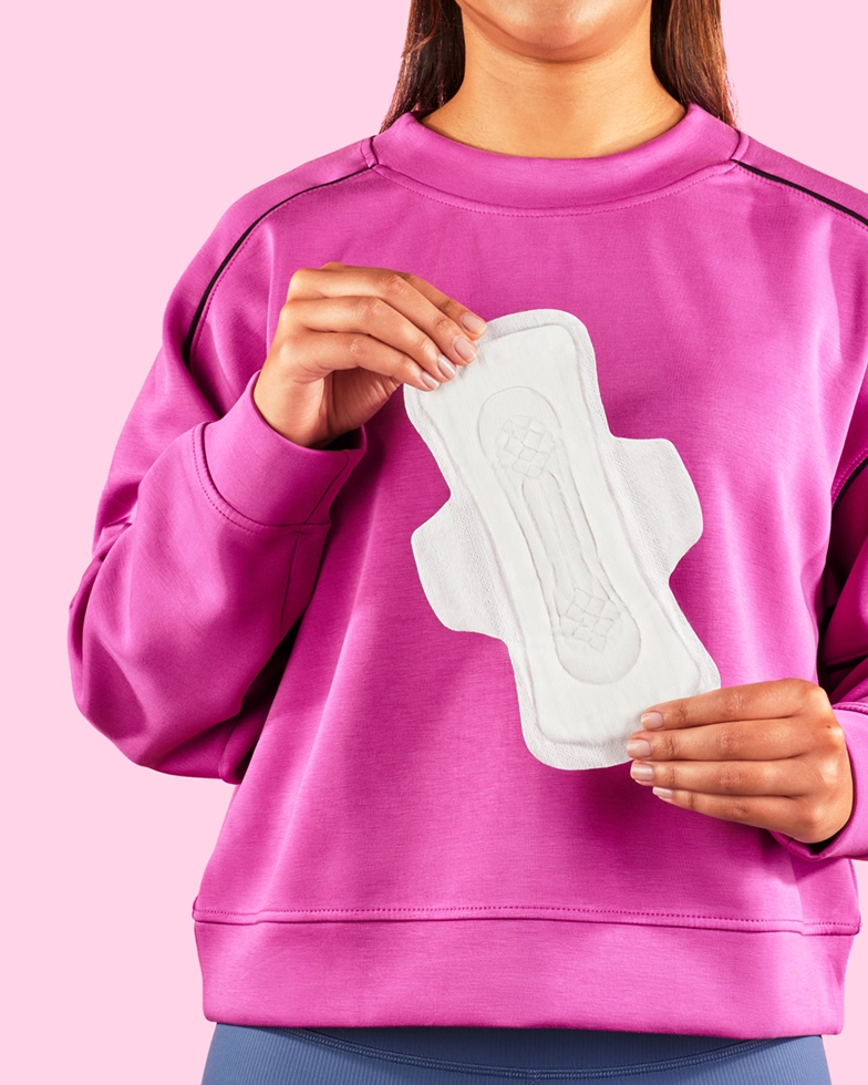 Woman holding a sanitary pad in her hand (Photo)