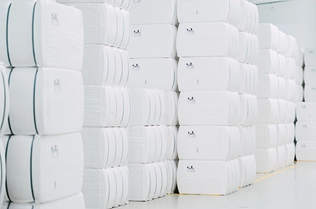 Tall stacks of white packages in a hall (Photo)